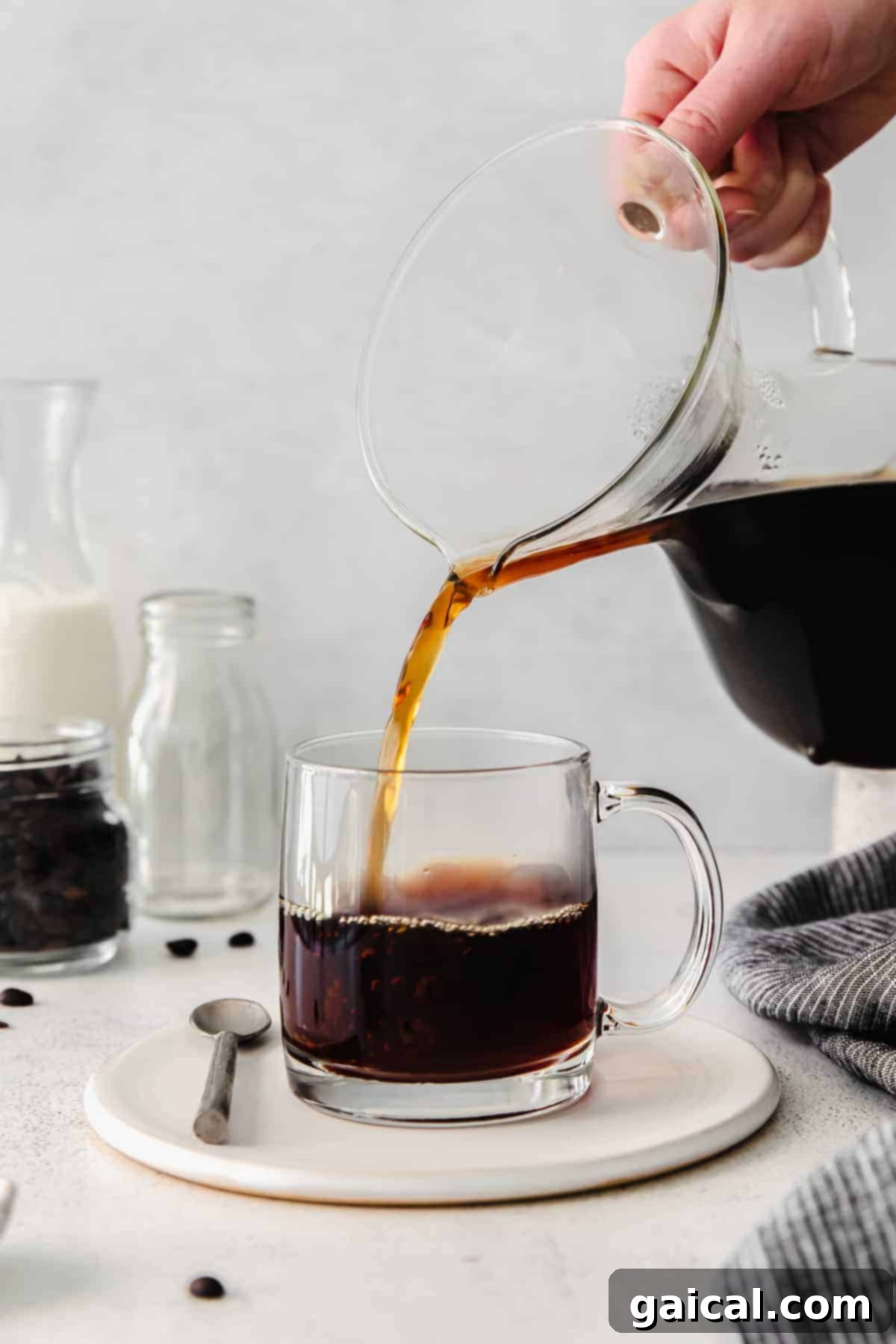 Pour over coffee is hands down the best kind of morning jo. Learn how to use your Chemex in this pour over coffee recipe tutorial. pouring coffee into mug