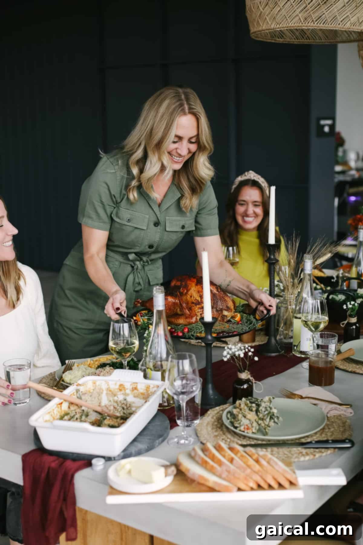 A woman elegantly placing a golden-brown smoked turkey on a beautifully set Thanksgiving table, surrounded by festive autumn decor.