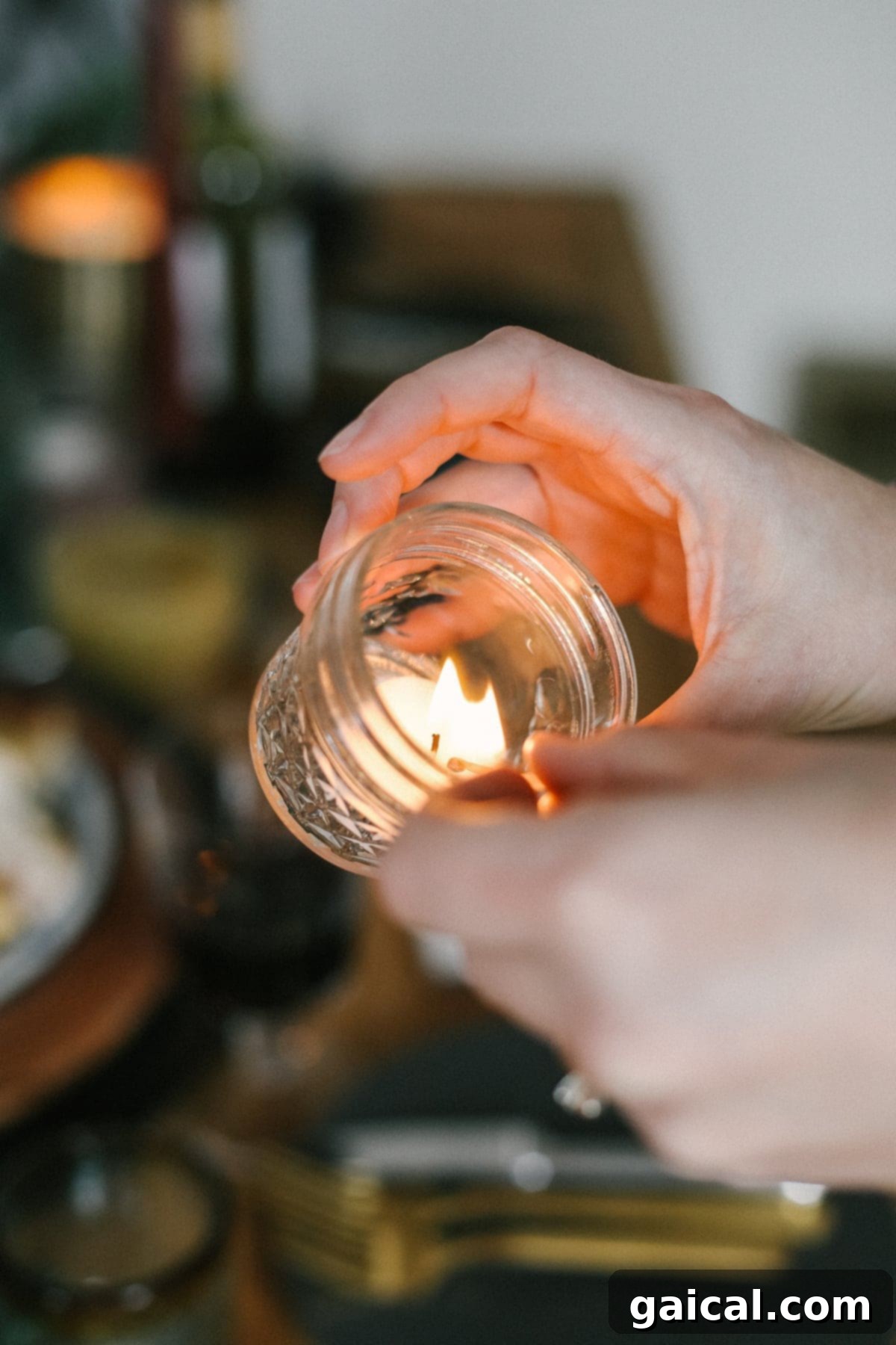 A charming glass jar repurposed as a candle holder, casting a warm glow, perfect for Thanksgiving decor.