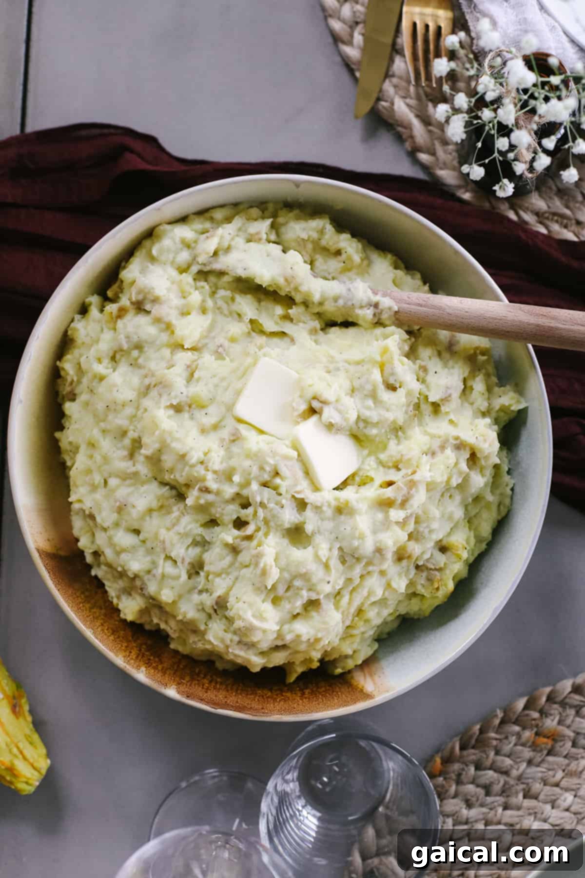 A serving bowl brimming with incredibly creamy and buttery Crockpot mashed potatoes, a perfect Thanksgiving side.