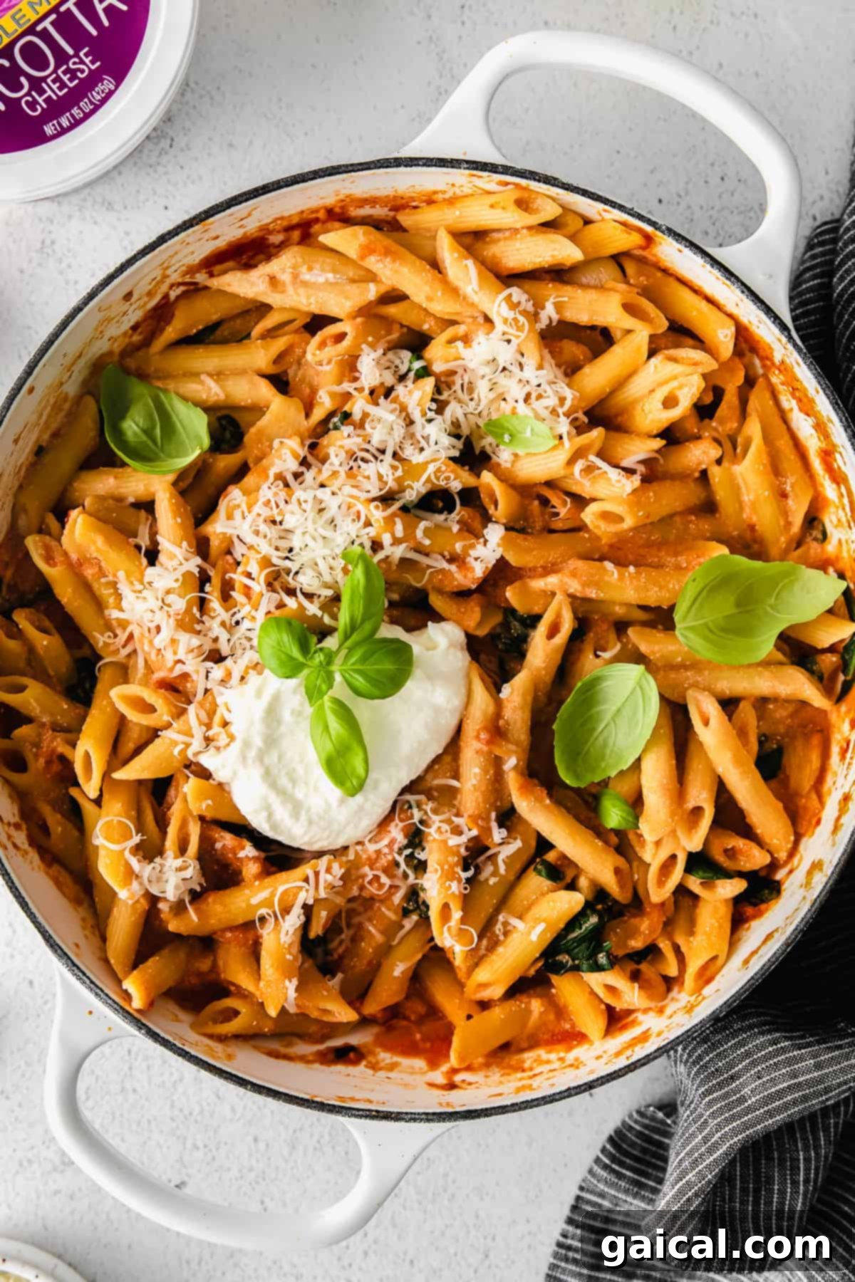 Whipped Ricotta Pasta: A Creamy Roasted Tomato & Garlic Delight Creamy whipped ricotta pasta in a Dutch oven with roasted tomatoes and garlic, ready to be served