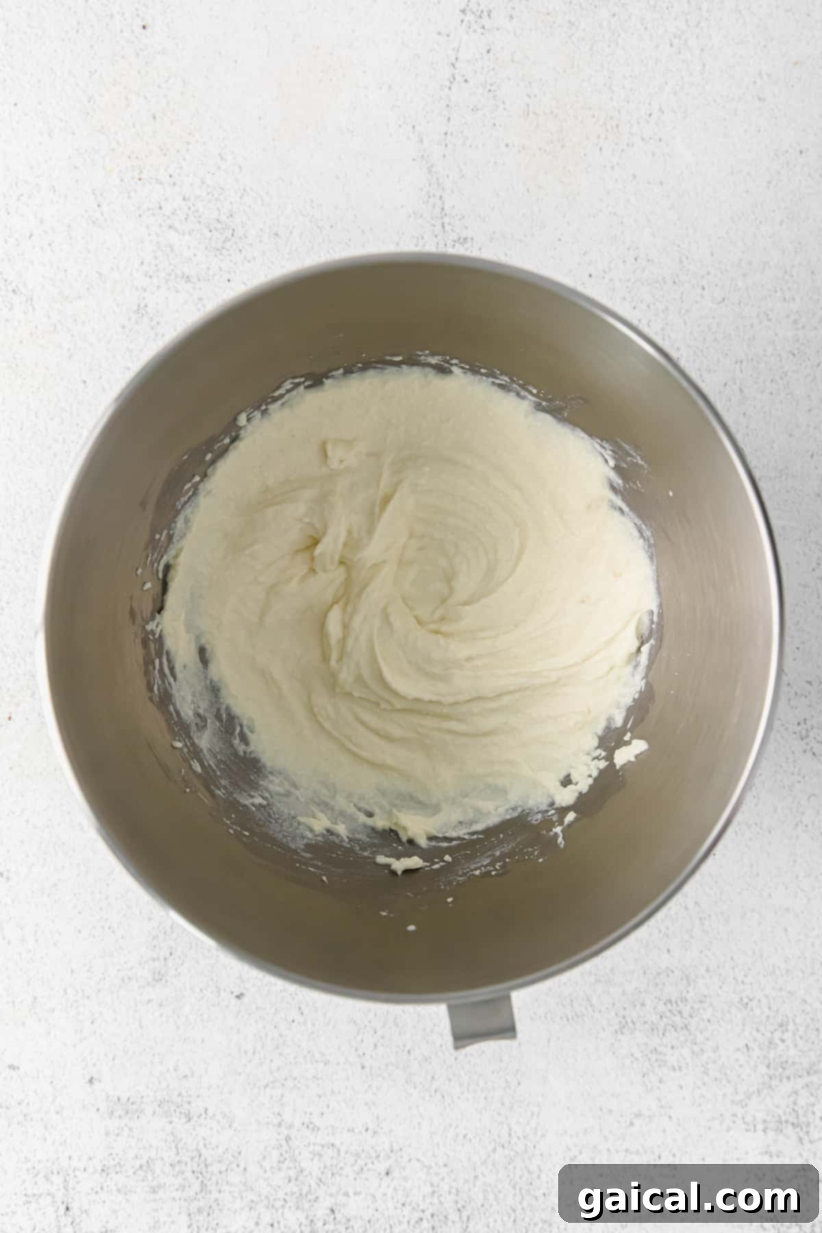 Fluffy Whipped Ricotta Freshly whipped ricotta cheese in a white bowl, looking light and airy, ready to be added to the pasta