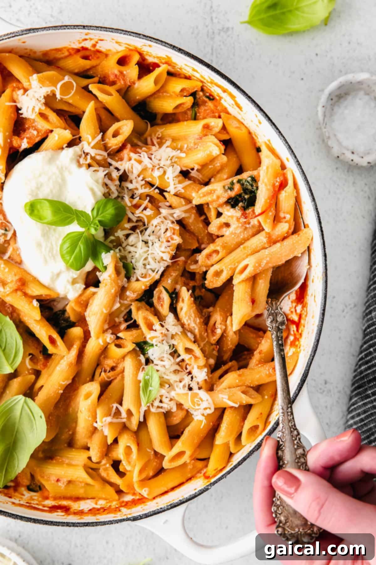 Serving Whipped Ricotta Pasta from Dutch Oven A generous serving of whipped ricotta pasta in a Dutch oven, garnished with fresh herbs and ready to be enjoyed