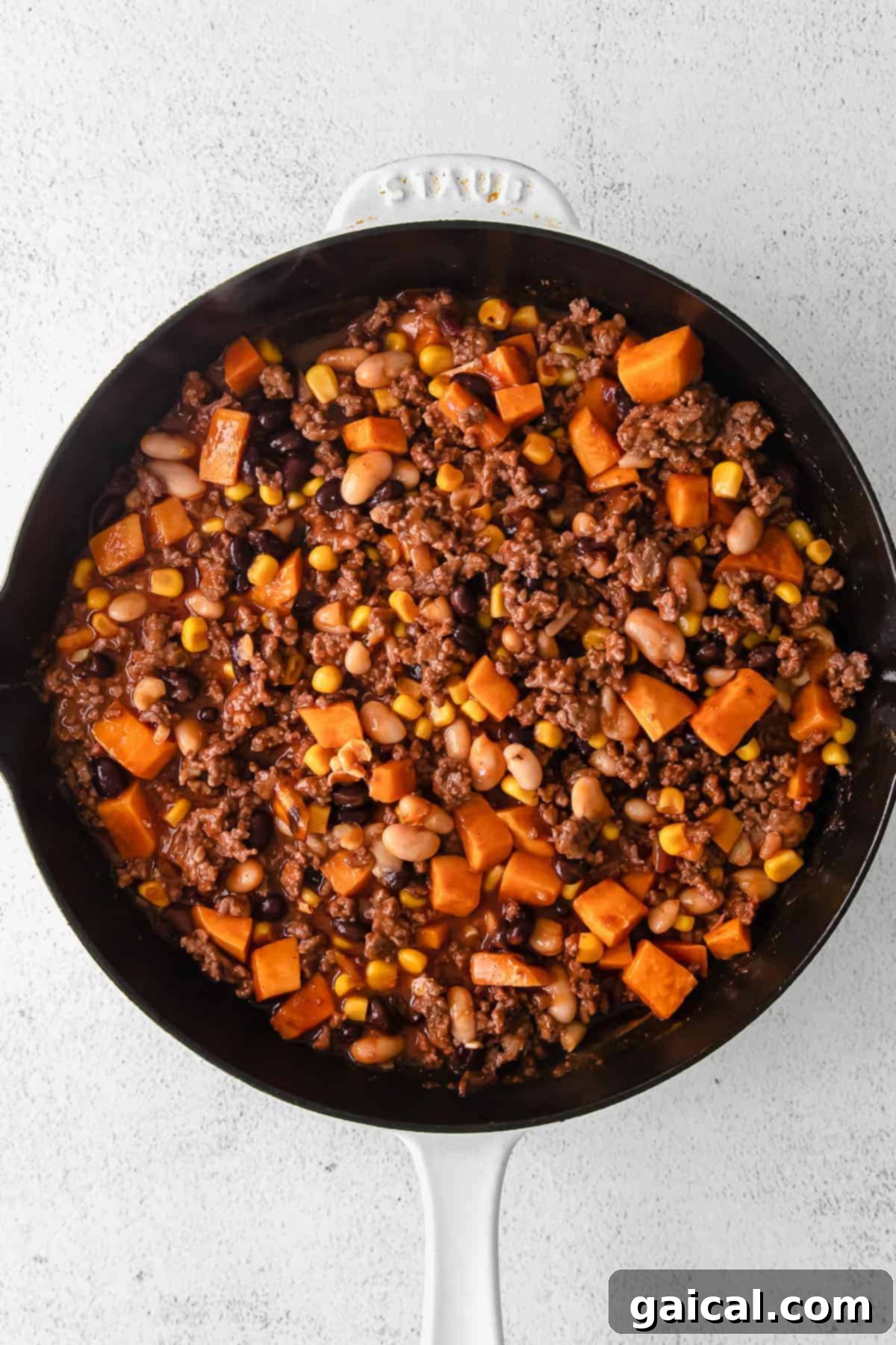 This turkey sweet potato enchilada skillet is a true one pot meal that comes together in 30 minutes flat. Enjoy this easy weeknight dinner tonight! enchilada skillet ingredients in a cast iron skillet