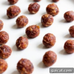 Salted Caramel Date Bites 6 Small, perfectly rolled date caramel balls arranged neatly on a plate, ready for the next step of chocolate coating.