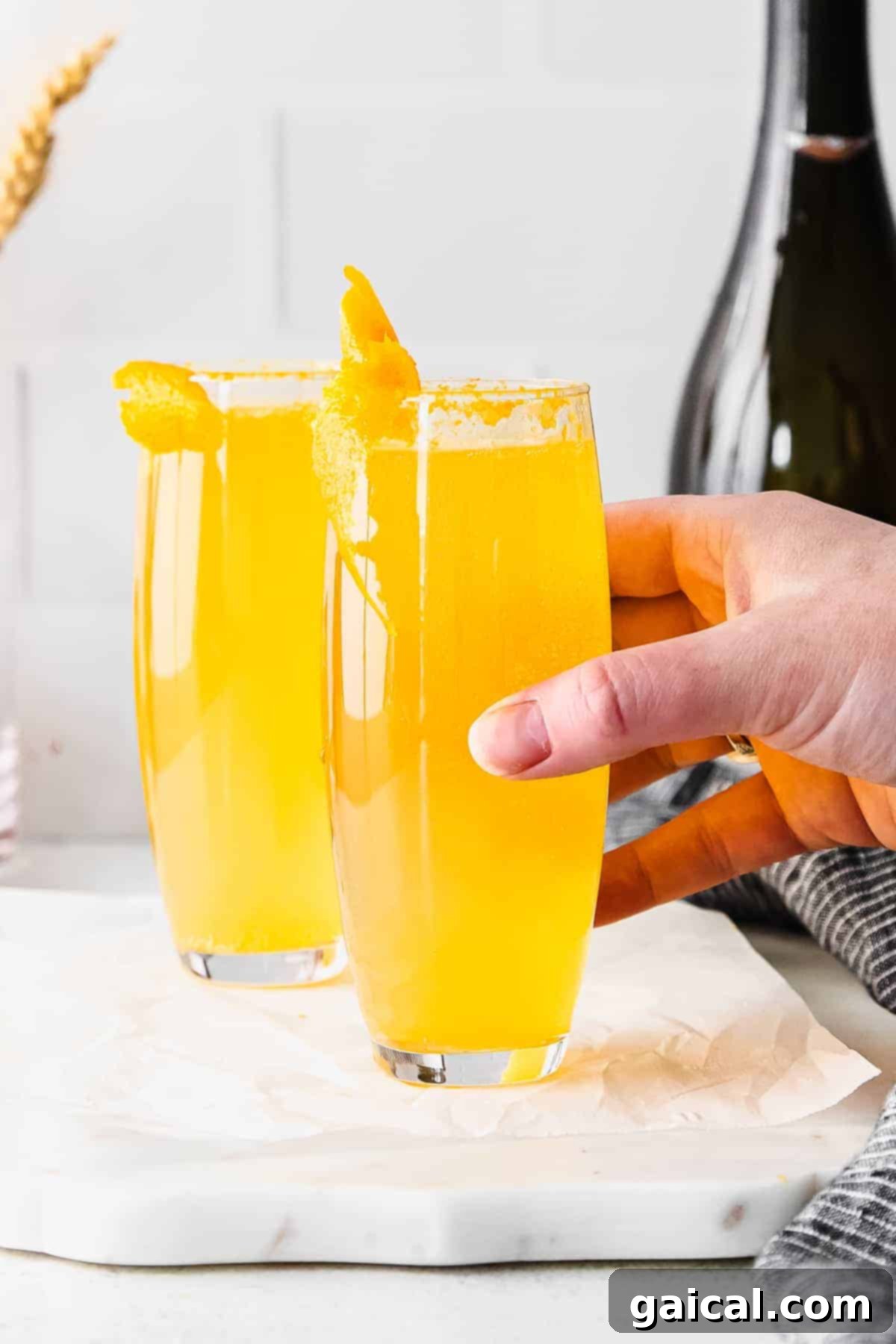 Classic Mimosa Ready to Serve A perfectly prepared classic mimosa in a stemless champagne flute, garnished with a fresh orange slice, glistening and ready to be enjoyed.