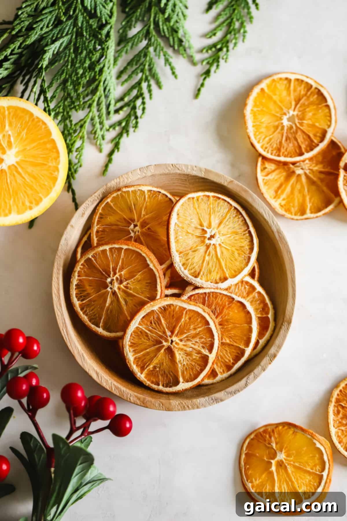 Dried orange garland is the perfect DIY holiday decor idea to add color and holiday cheer to any room in your home. A festive bowl filled with an abundance of dried orange slices, ready to be used in various holiday decorating projects.