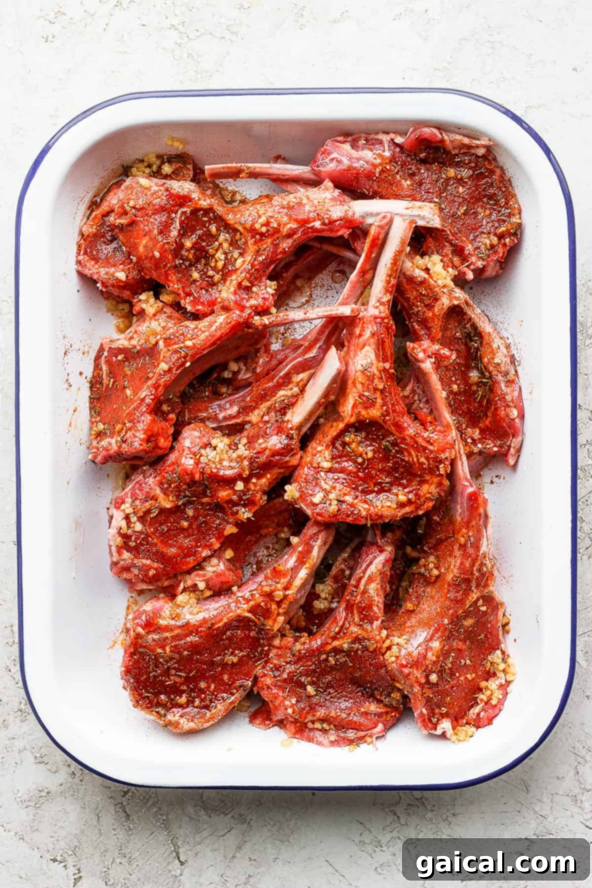 Seasoned Raw Lamb Chops Ready for Marination Raw lamb chops generously seasoned with a homemade dry rub, ready for marinating.