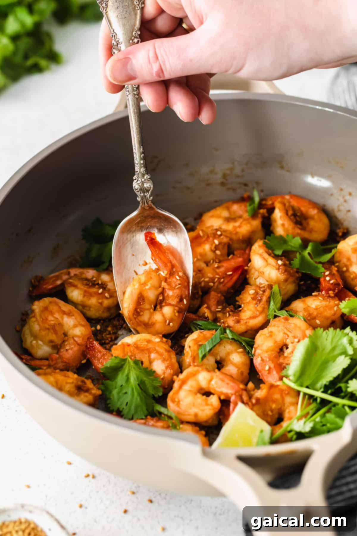 Zesty Lemon Garlic Shrimp 8 Delicious sautéed shrimp adorned with fresh sesame seeds and cilantro, ready to be served.