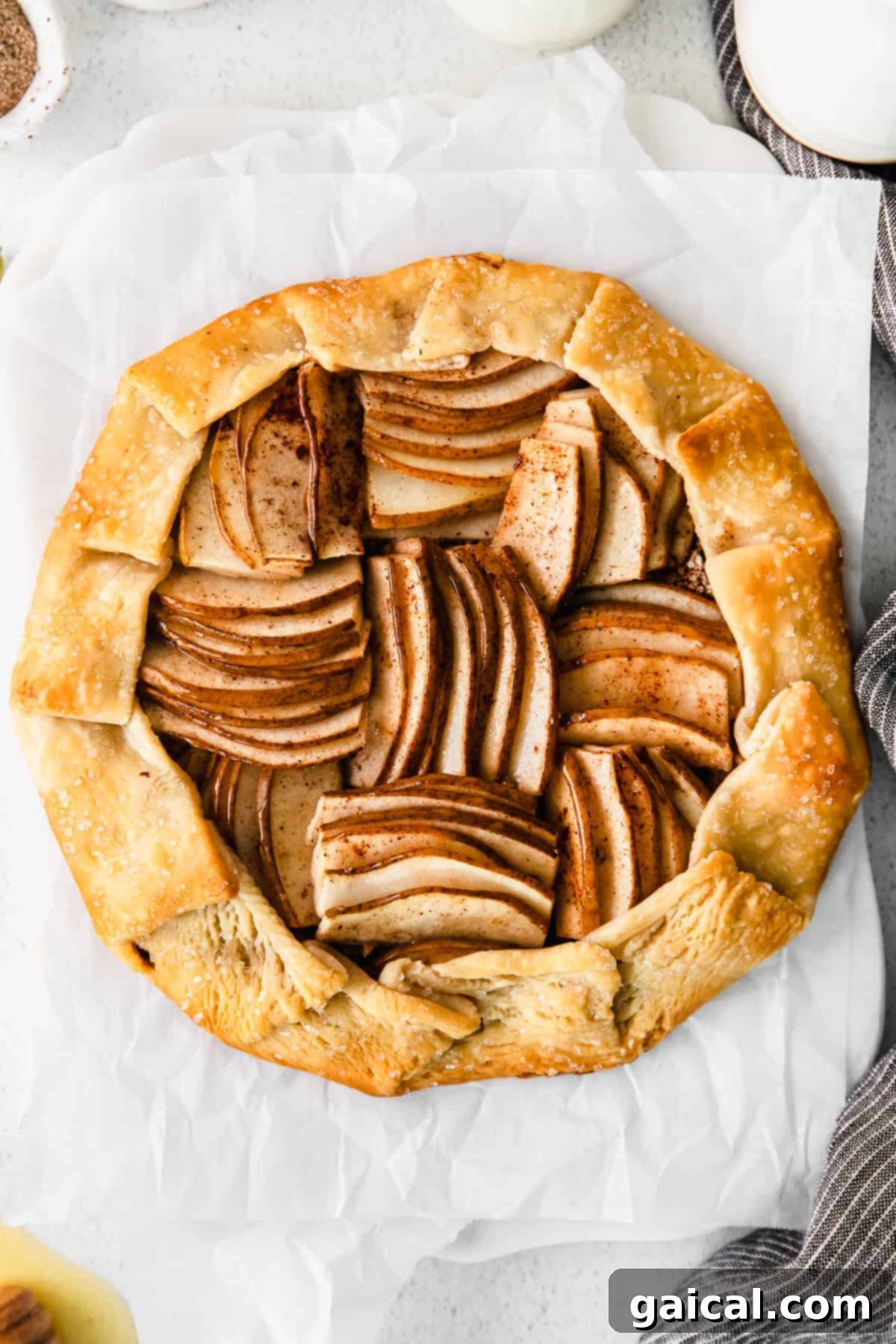 A beautifully baked honey pear galette, golden brown and garnished.