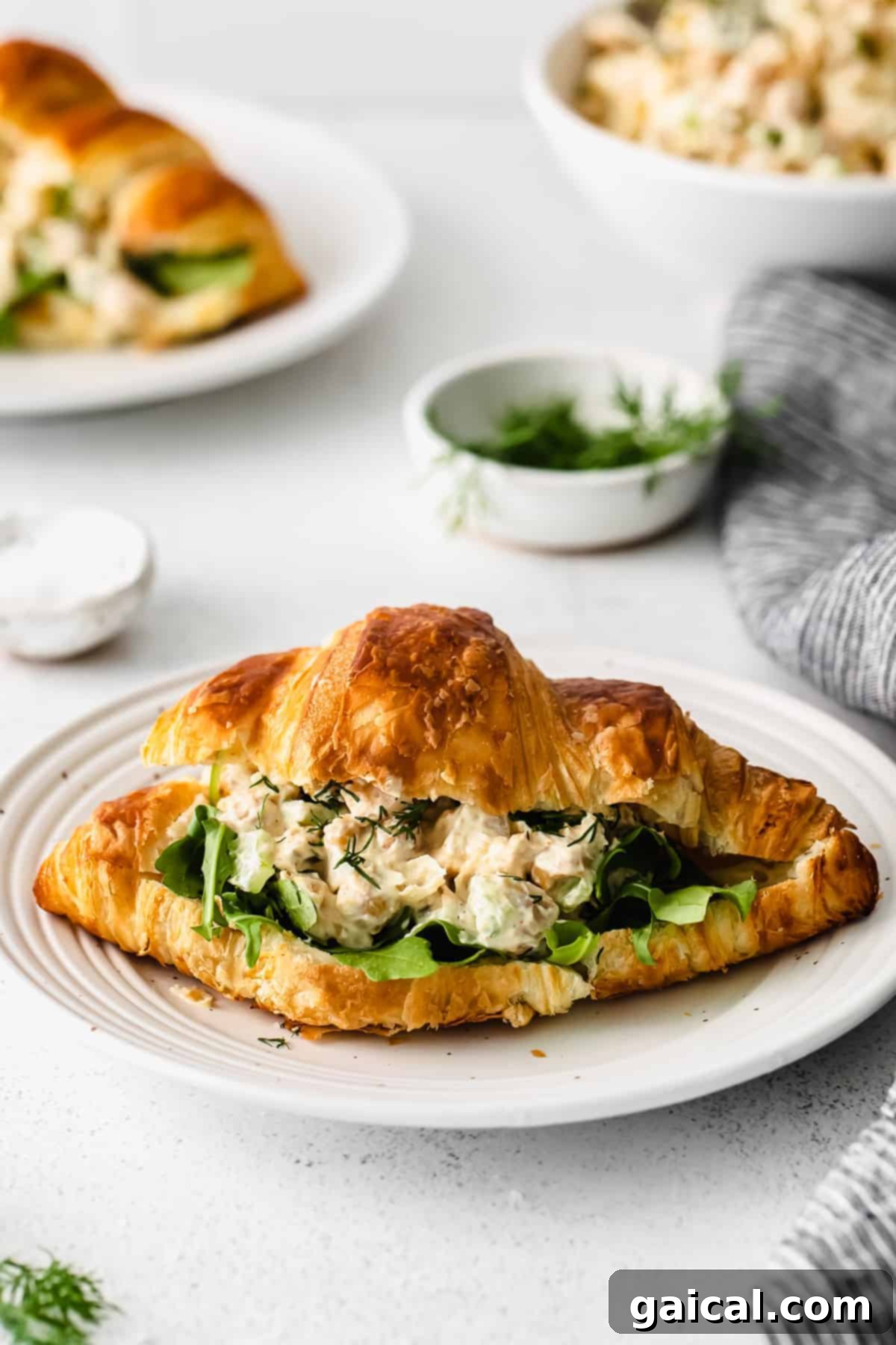 Delicious chickpea salad served on a flaky croissant, ready to be enjoyed as a sandwich.