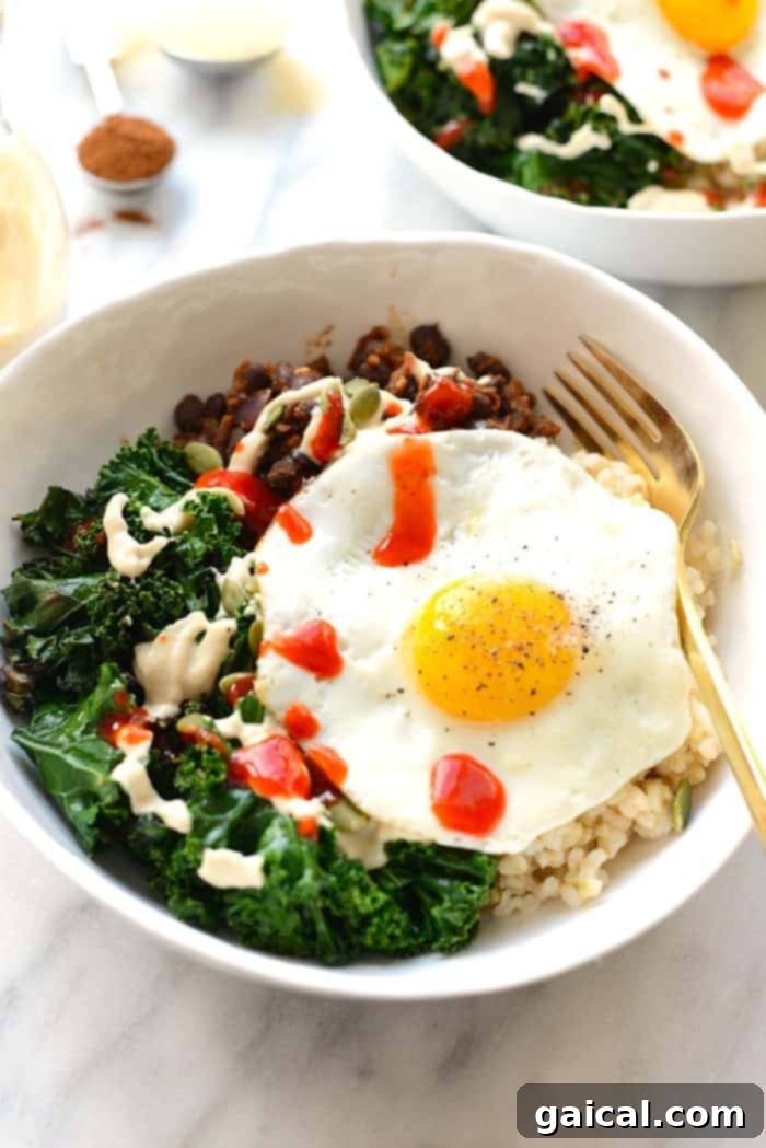 A vibrant black bean breakfast bowl with a perfectly fried egg, sautéed kale, and brown rice, ready for a healthy start to the day.