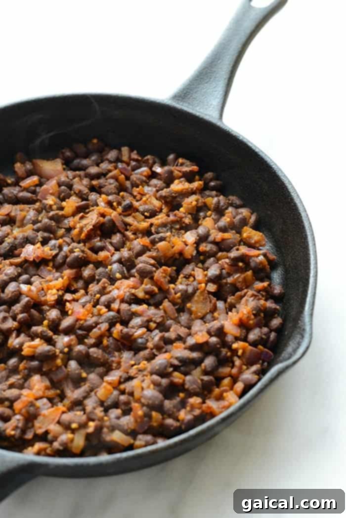 Close-up of the delicious ingredients for a savory breakfast bowl, highlighting fresh black beans, kale, and fluffy brown rice.