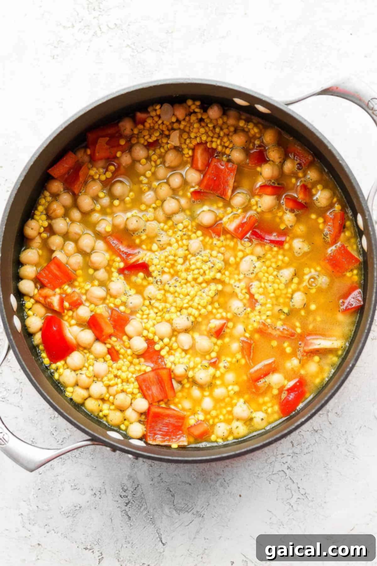 Zesty Lemon Garlic Israeli Couscous with Creamy Feta 5 A deliciously cooked one-pot Lemon Garlic Israeli Couscous dish, ready to be topped with creamy whipped feta and tangy pickled vegetables for a complete meal.