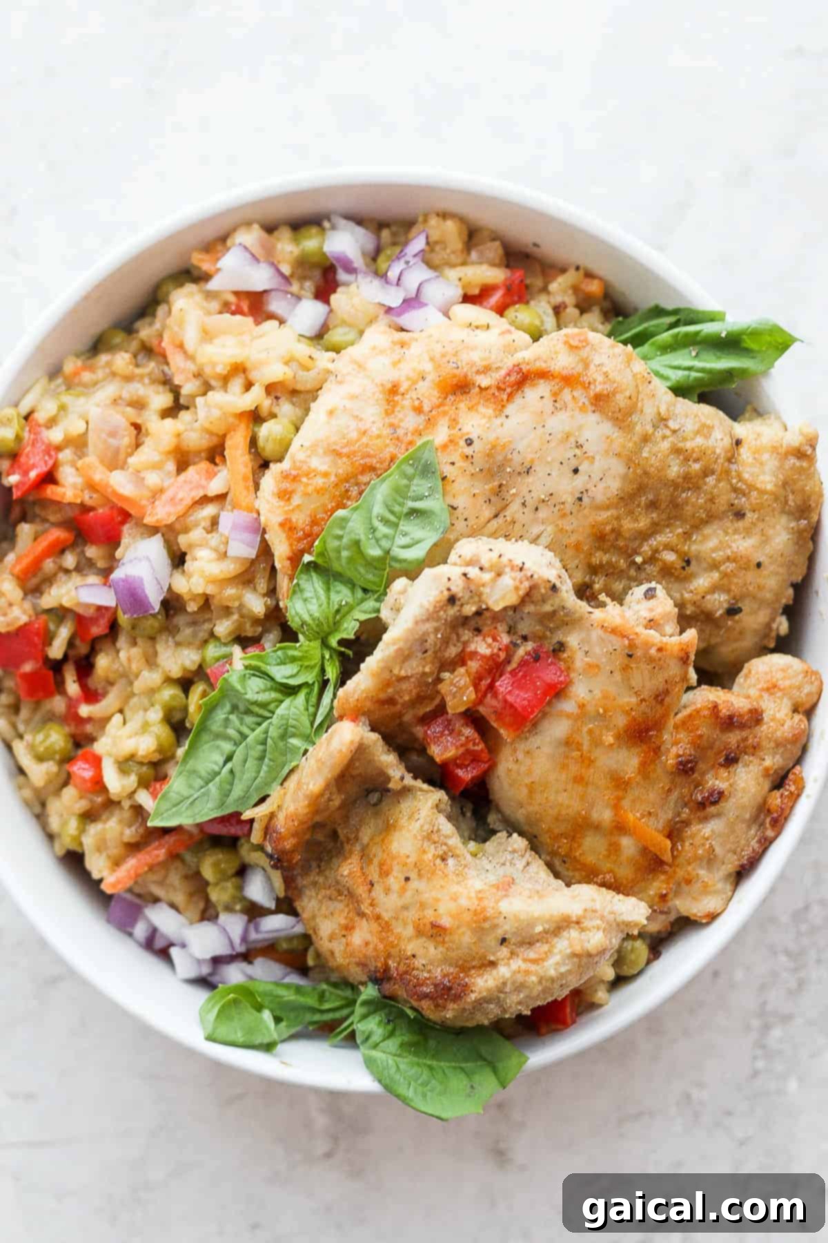 One-Pot Green Curry Chicken and Rice on Plate A beautifully plated serving of one-pot green curry chicken and rice garnished with fresh cilantro and a lime wedge, ready to be enjoyed.