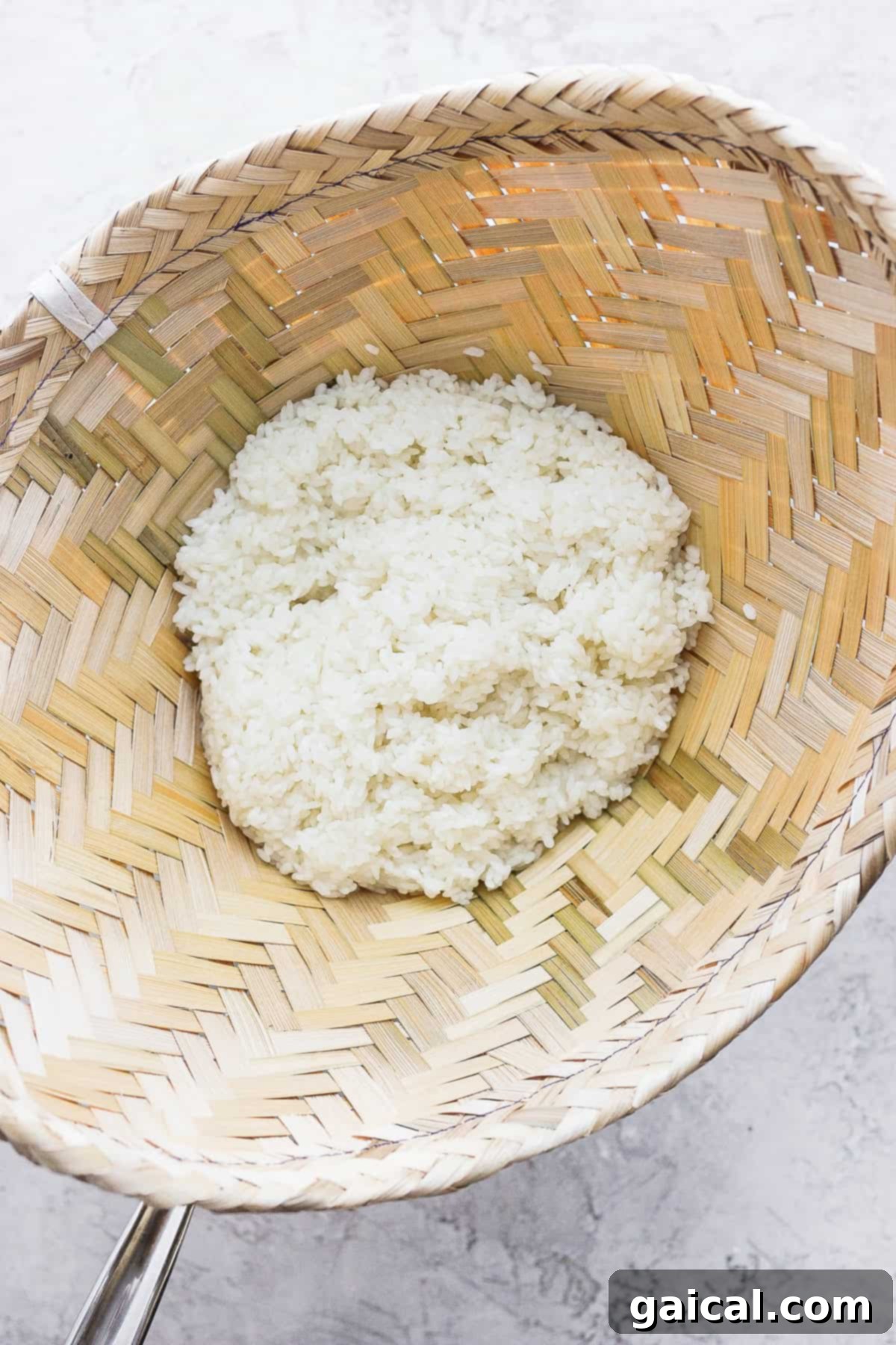 Freshly steamed sticky rice inside a traditional bamboo basket, ready to be served.