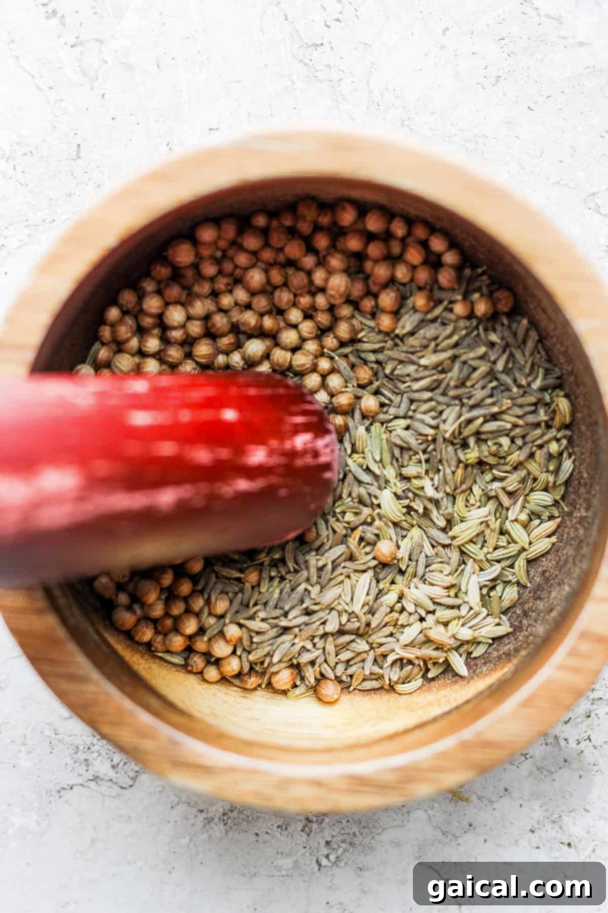 Grinding Whole Spices for Fresh Za'atar Seasoning Za'atar seasoning ingredients being prepared in a mortar and pestle.