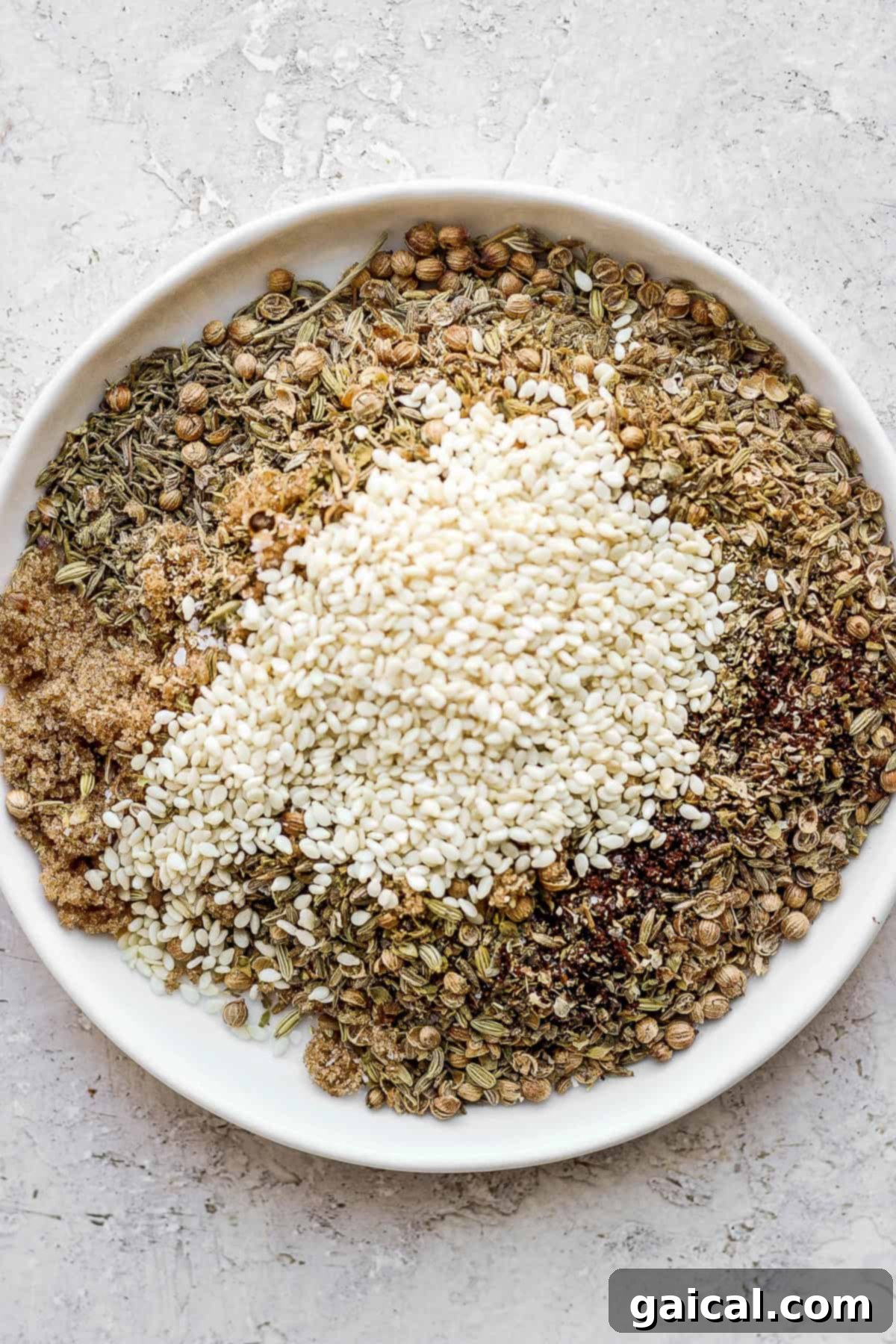 Individual Spices for a Perfectly Balanced Za'atar Blend Various individual spices for za'atar seasoning displayed on a plate.