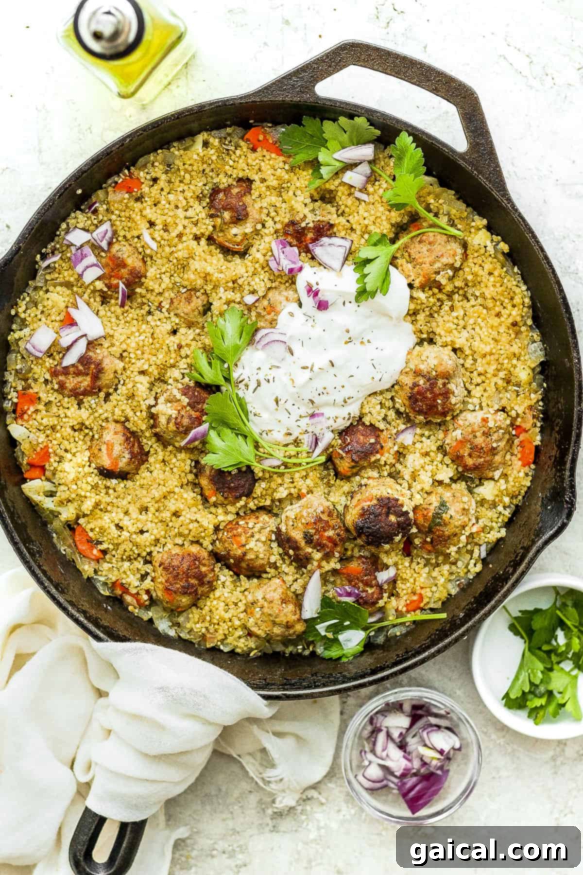 Effortless Za'atar Meatball Quinoa Skillet 2 A vibrant One-Pot Za'atar Meatballs and Quinoa dish served in a rustic cast iron skillet, garnished with fresh herbs and a drizzle of creamy yogurt sauce, ready to be enjoyed.