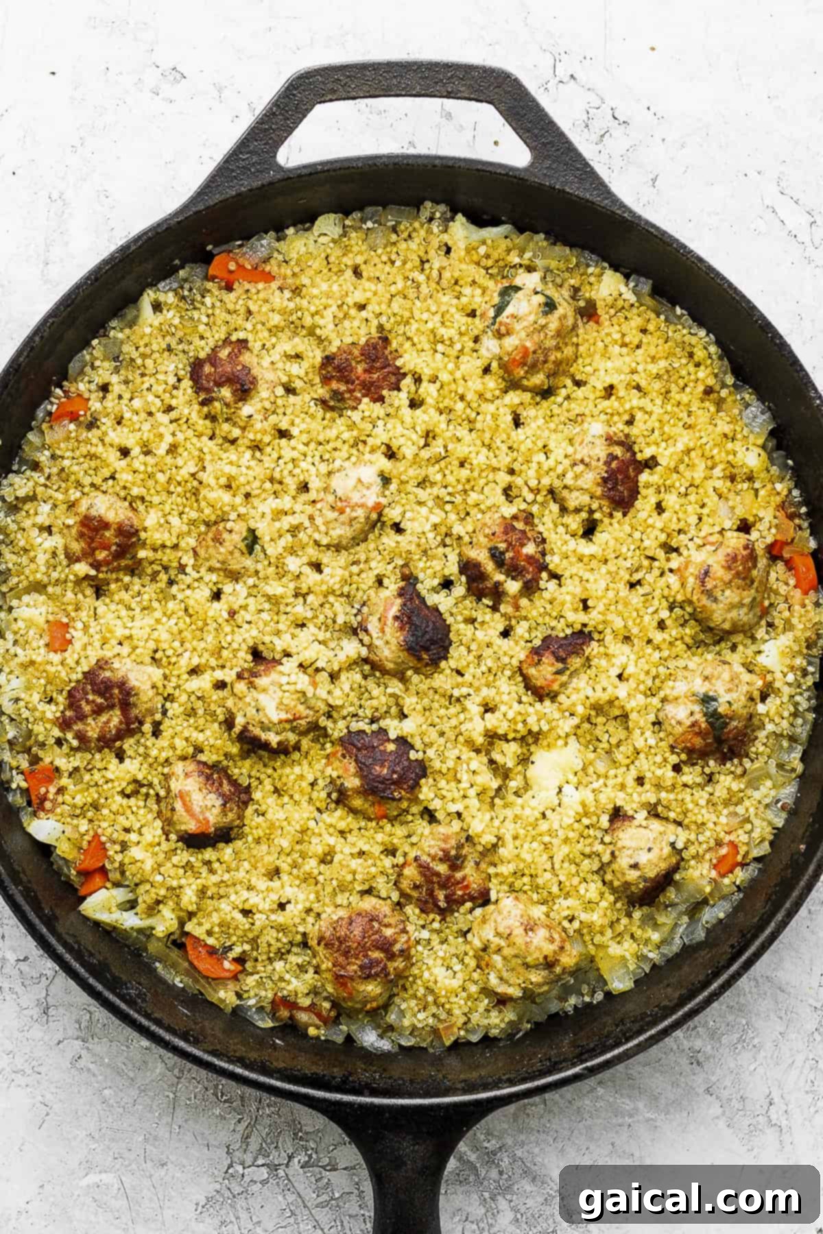 Effortless Za'atar Meatball Quinoa Skillet 7 A close-up of the One-Pot Za'atar Meatballs and Quinoa in a cast iron skillet, steaming gently, ready for the final touch of the lemon yogurt topping.