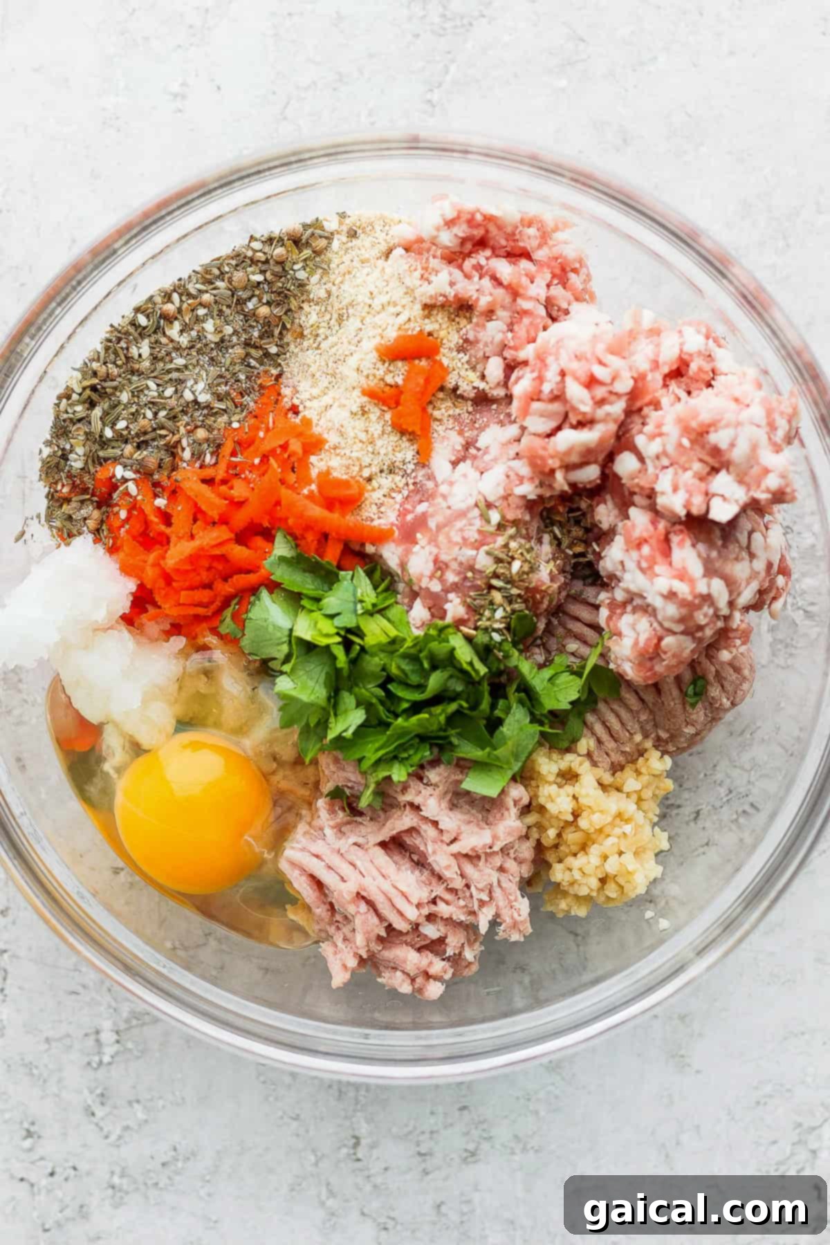 Effortless Za'atar Meatball Quinoa Skillet 3 A selection of fresh ingredients neatly arranged in bowls, including ground meats, quinoa, various spices, and colorful vegetables, all prepped for the One-Pot Za'atar Meatballs and Quinoa recipe.