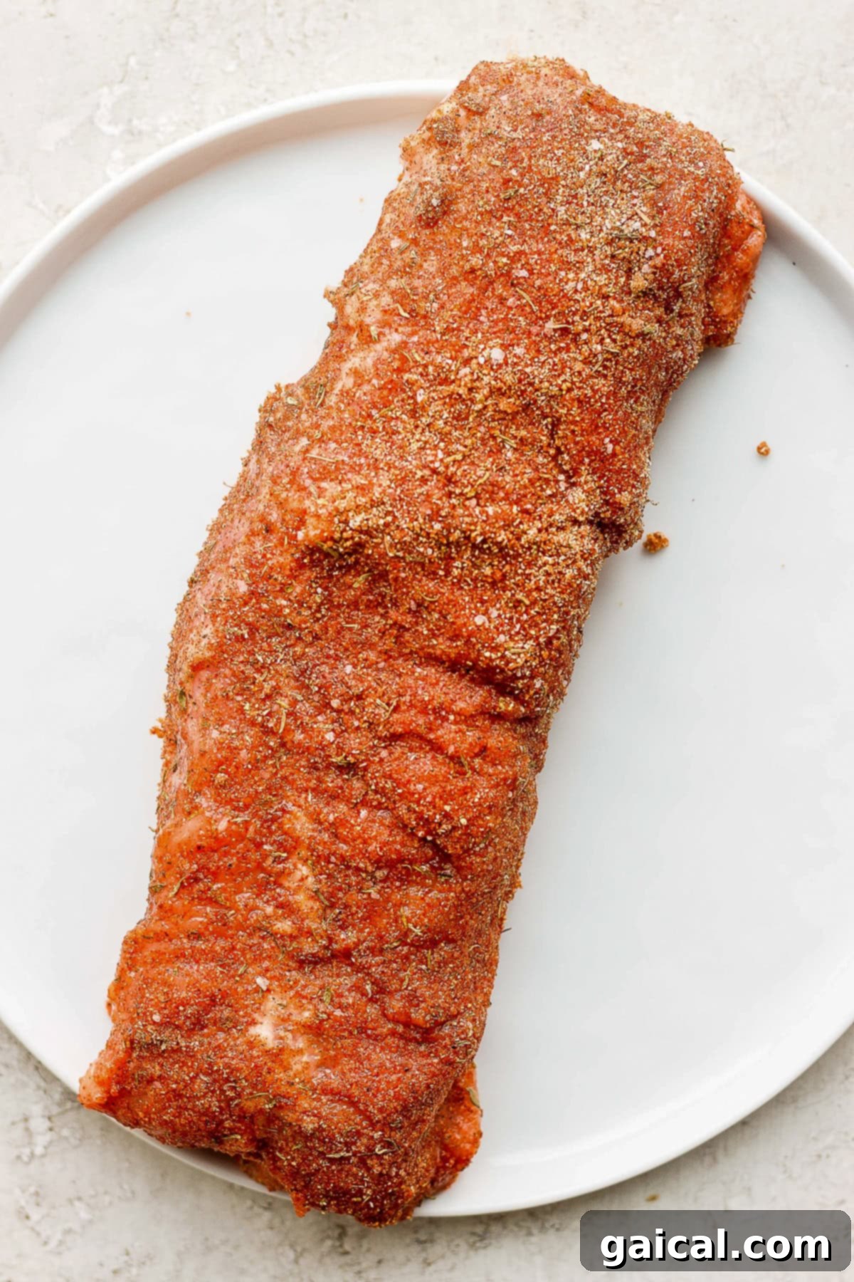 This Air Fryer Pork Tenderloin recipe is super moist on the inside with a crispy outside and is ready to enjoy in minutes. A raw pork tenderloin liberally coated with a savory dry rub, ready for cooking.
