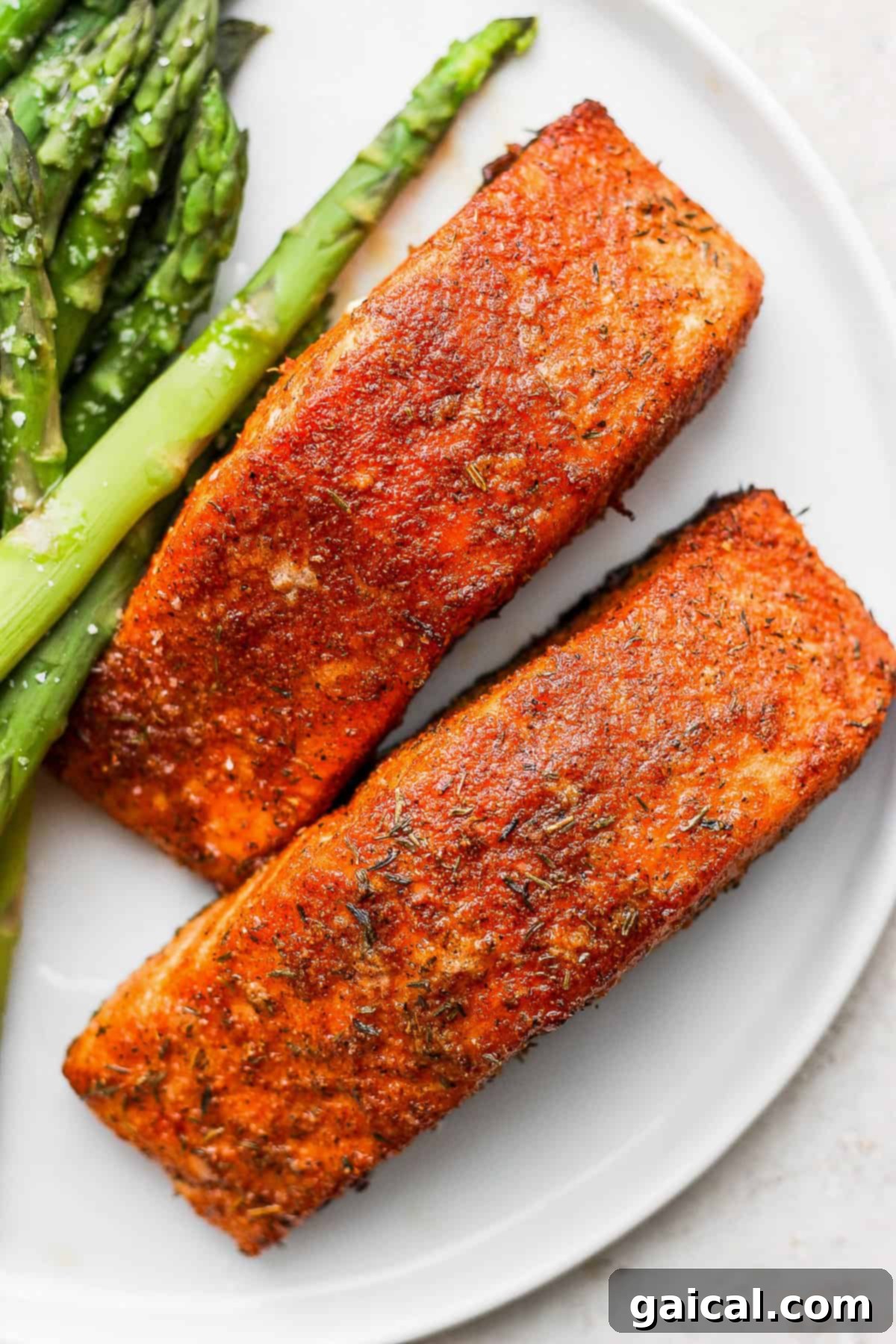 Perfectly cooked salmon fillet on a plate, showcasing its crispy skin and flaky texture, ready to be enjoyed.