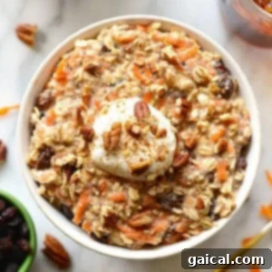 A bowl of Carrot Cake Overnight Oats topped with whipped cream and a sprinkle of cinnamon, illustrating a decadent breakfast treat.