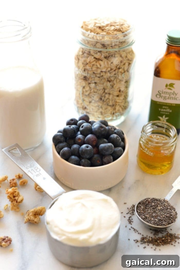 Fresh Ingredients for Wholesome Blueberry Overnight Oats A flat lay photograph showcasing all the fresh and wholesome ingredients for making blueberry overnight oats, including rolled oats, fresh blueberries, Greek yogurt, honey, almond milk, chia seeds, vanilla extract, and a lemon.