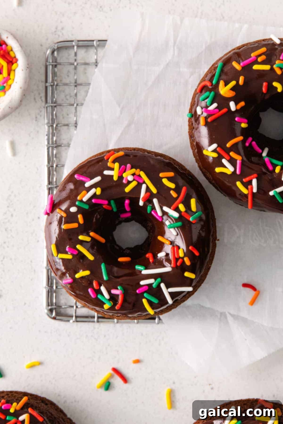 Tender Chocolate Baked Donut with Frosting and Sprinkles Freshly baked chocolate donut cooling on a wire rack, ready for frosting