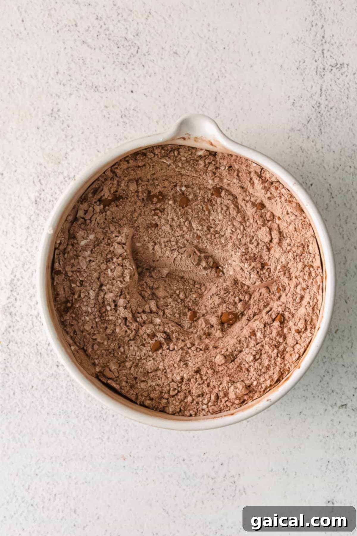 Dry Ingredients for Homemade Chocolate Donuts Bowl with dry ingredients for chocolate baked donuts, including flour and cocoa powder