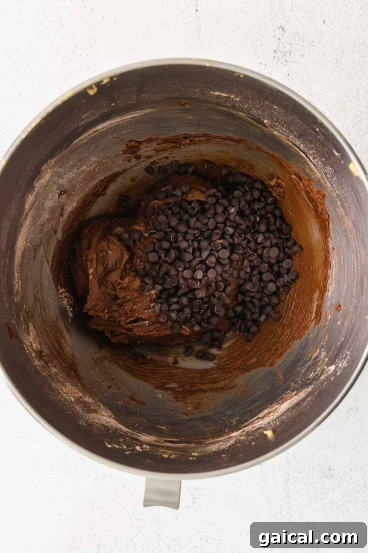 Smooth Chocolate Donut Batter Chocolate donut batter in a mixing bowl, smooth and ready to be piped
