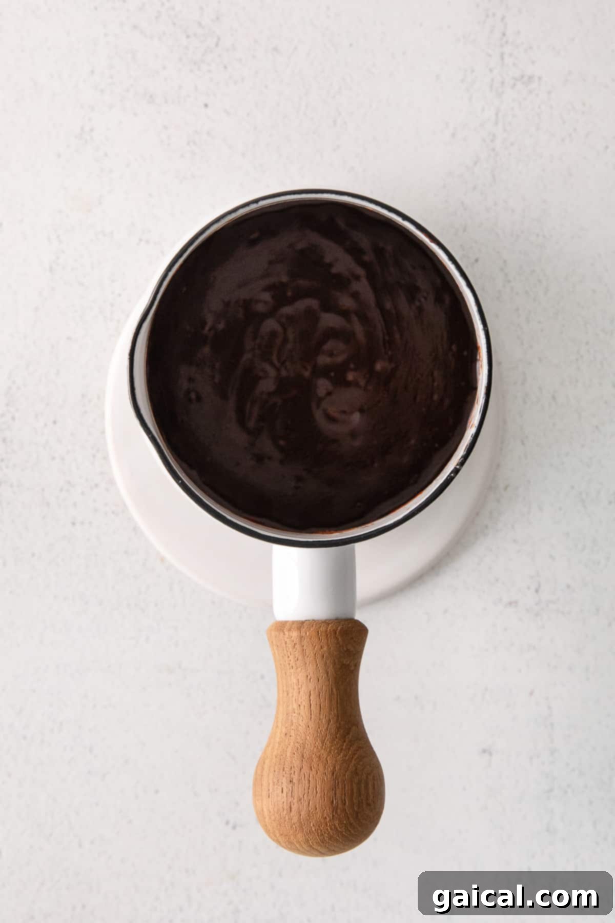 Perfect Chocolate Donut Glaze Smooth chocolate glaze in a small white bowl