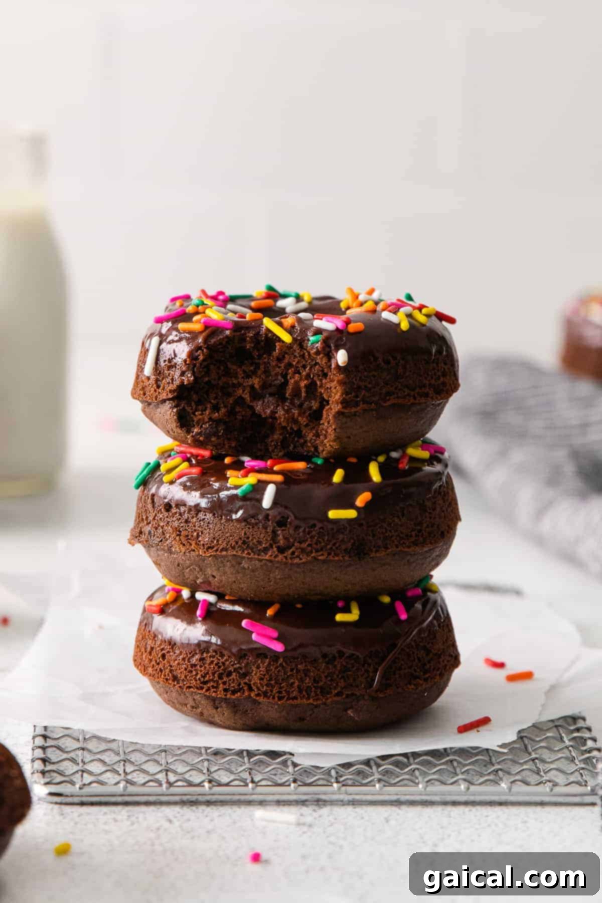 Stack of Delicious Chocolate Donuts Stack of four glazed chocolate baked donuts with sprinkles