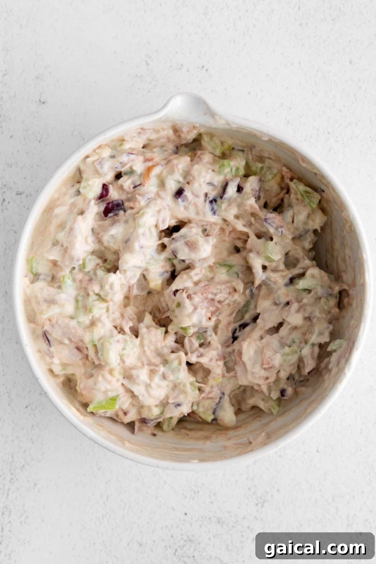 A vibrant bowl of healthy tuna salad, garnished with fresh herbs and spices, perfect for a wholesome and satisfying meal.