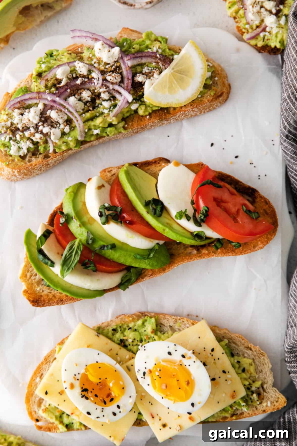 Avocado toast topped with fresh Caprese ingredients: sliced tomatoes, mozzarella, and basil