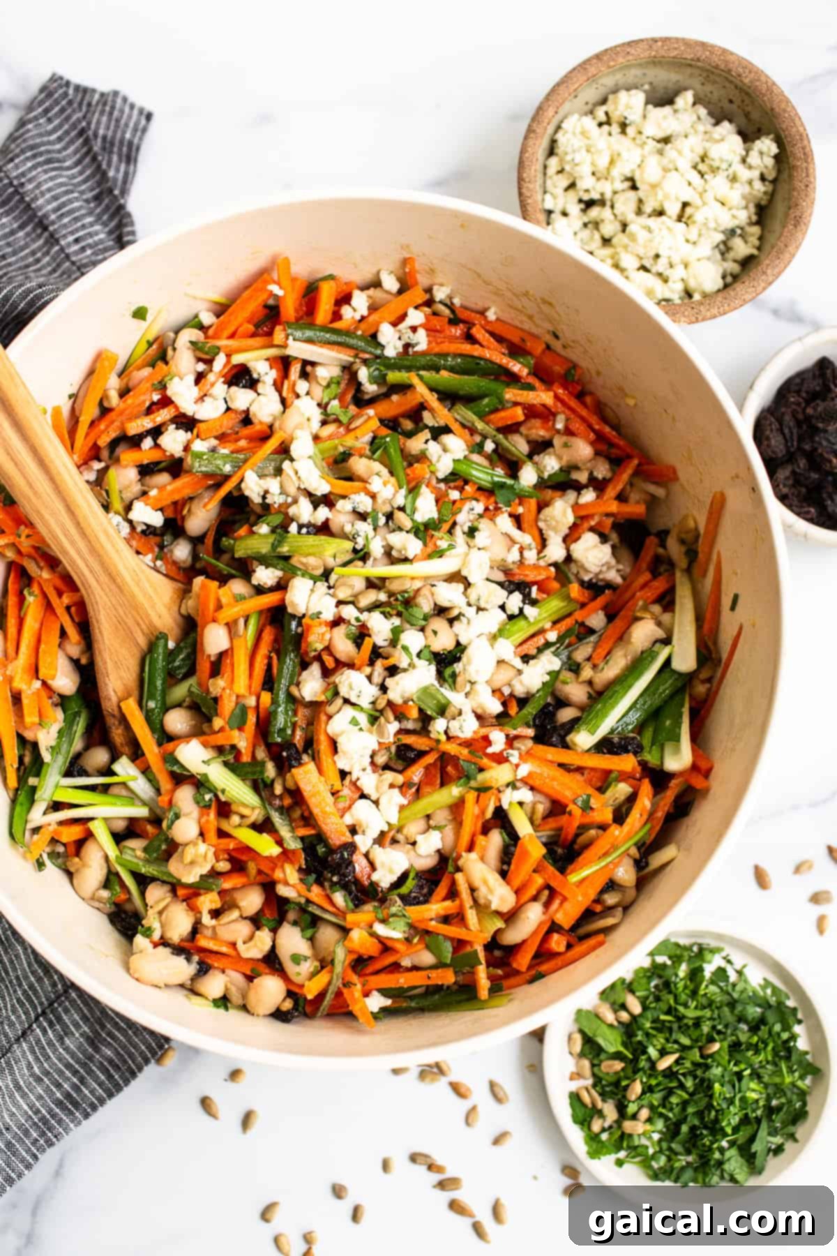 A beautifully presented French Carrot Salad in a rustic bowl, showcasing its vibrant orange carrots, green onions, and creamy dressing.