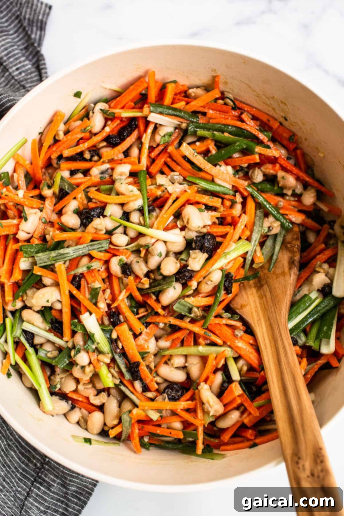 A close-up shot of the French Carrot Salad in a bowl, highlighting its vibrant colors and appealing textures.
