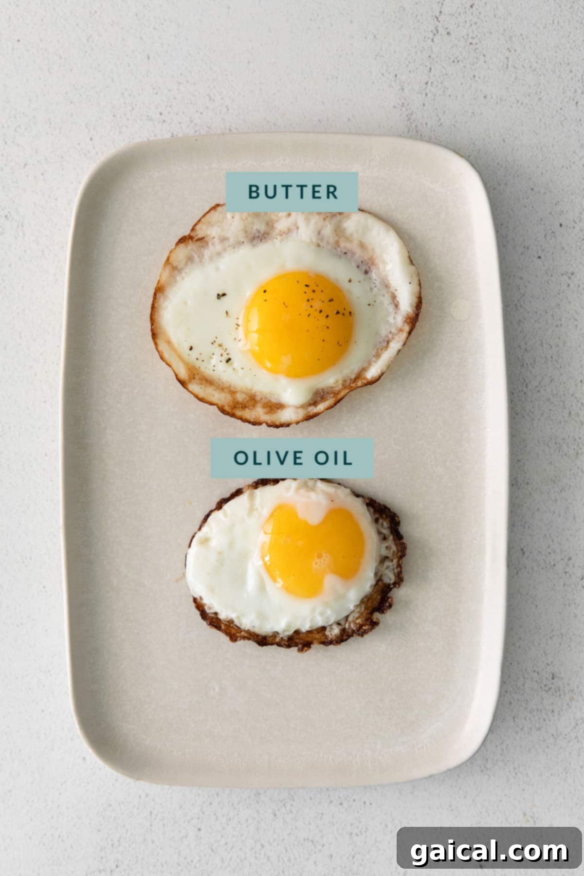 Fry the Perfect Egg 4 A comparison plate showing an egg fried in butter with soft, tender edges, next to an egg fried in oil with crispy, browned edges.