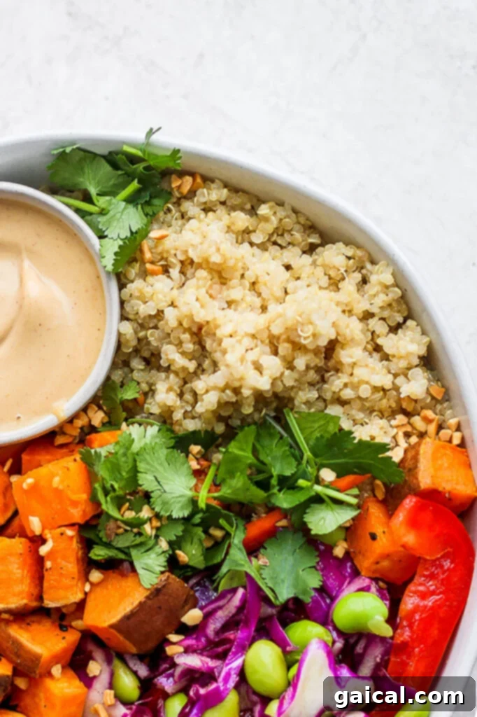 Tropical Coconut Quinoa 2 A beautifully presented bowl of creamy coconut quinoa salad with fresh vegetables and a vibrant dipping sauce, ready to be savored.