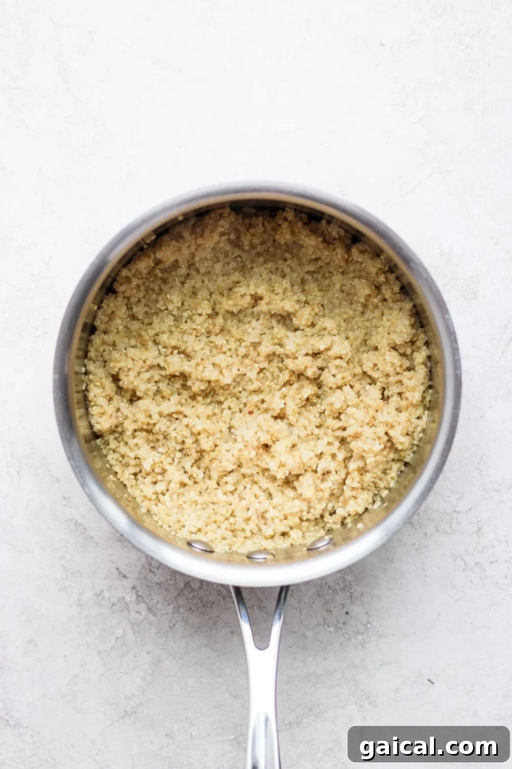 Tropical Coconut Quinoa 5 Perfectly cooked, fluffy coconut quinoa resting invitingly in a saucepan, ready to be served or added to a delicious meal.