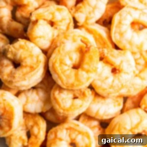 Cooked shrimp in a pan, showing a vibrant pink color