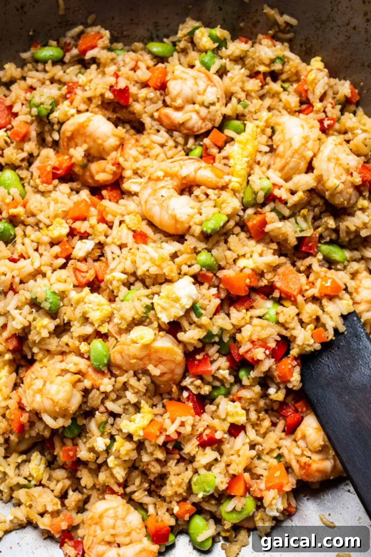 Sizzling Shrimp Fried Rice in a Skillet Shrimp fried rice sizzling in a hot skillet, showcasing the vibrant colors of shrimp, rice, and vegetables.