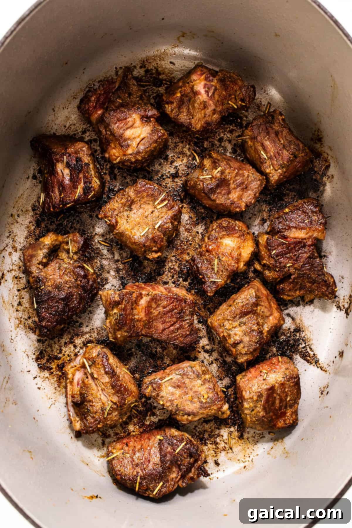 Deeply browned beef chunks in a Dutch oven, building a flavorful foundation for the stew.