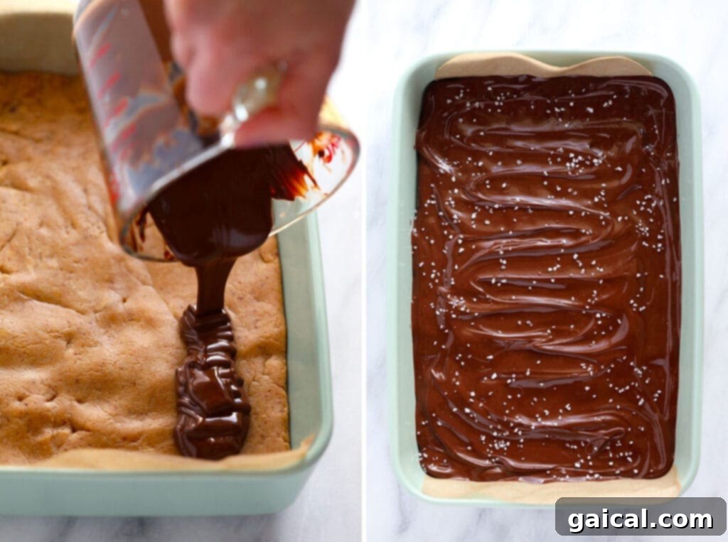 Adding an Irresistible Chocolate Topping to Your Protein Bars. Hands carefully pouring melted chocolate topping over a tray of homemade peanut butter protein bars, creating a luscious layer.