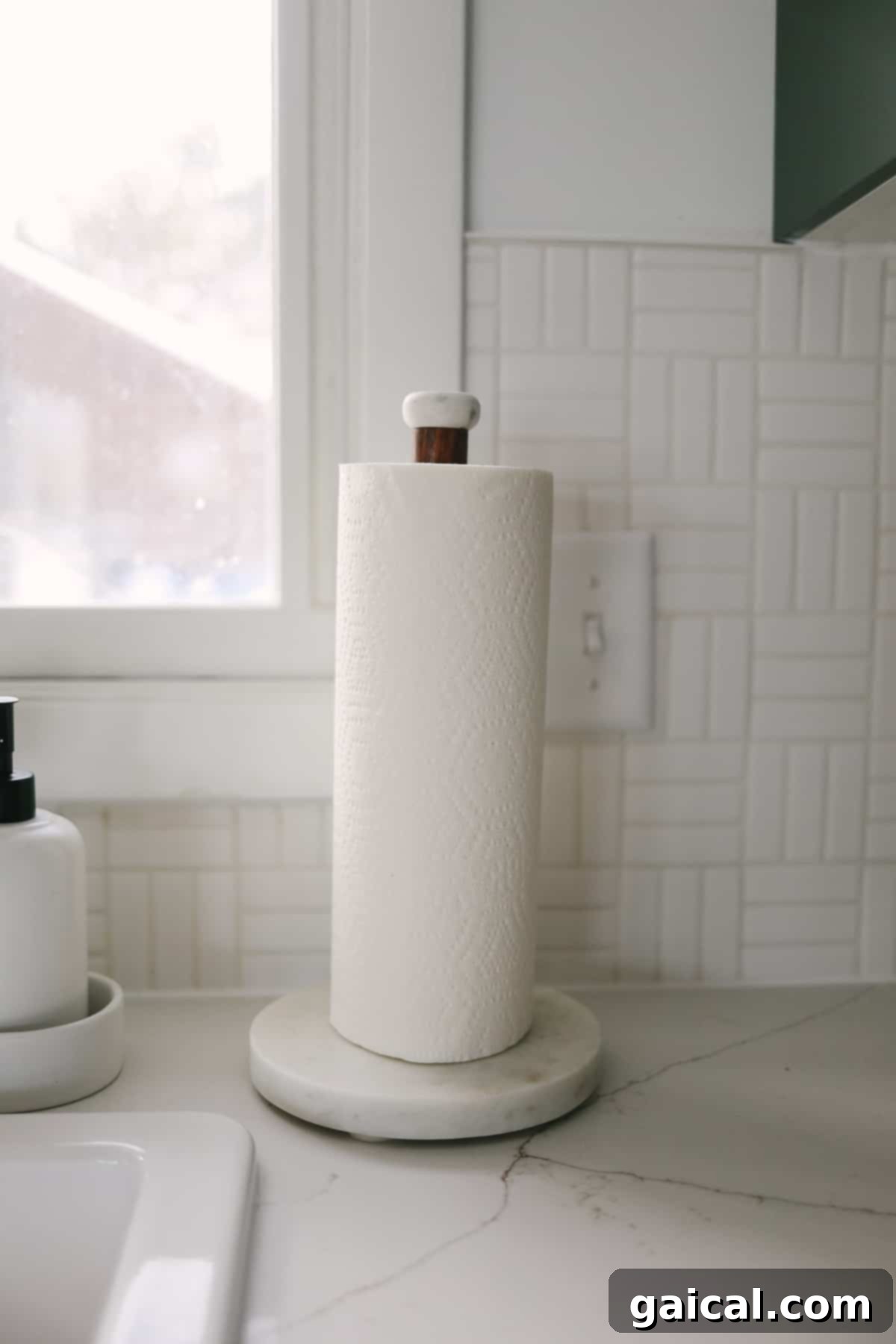 Paper towel holder against Daltile lattice weave backsplash