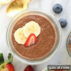 Three jars of protein-packed chia seed pudding topped with berries and banana slices.