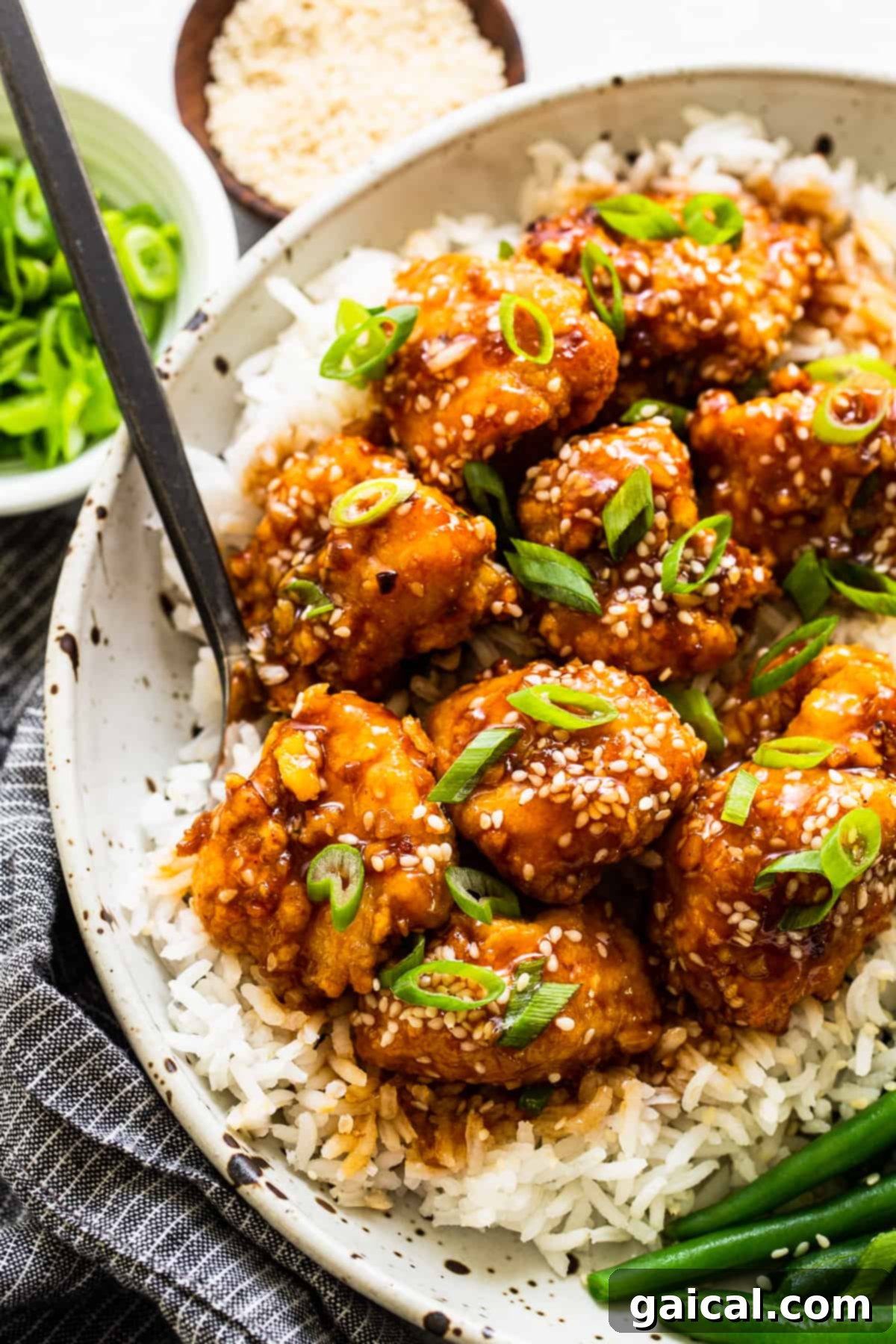 You will love this air fryer honey sesame chicken recipe. It's made with lean chicken breast and a yummy honey sesame sauce and then air-fried to make the chicken super crispy without deep frying. Air Fryer Honey Sesame Chicken in bowl