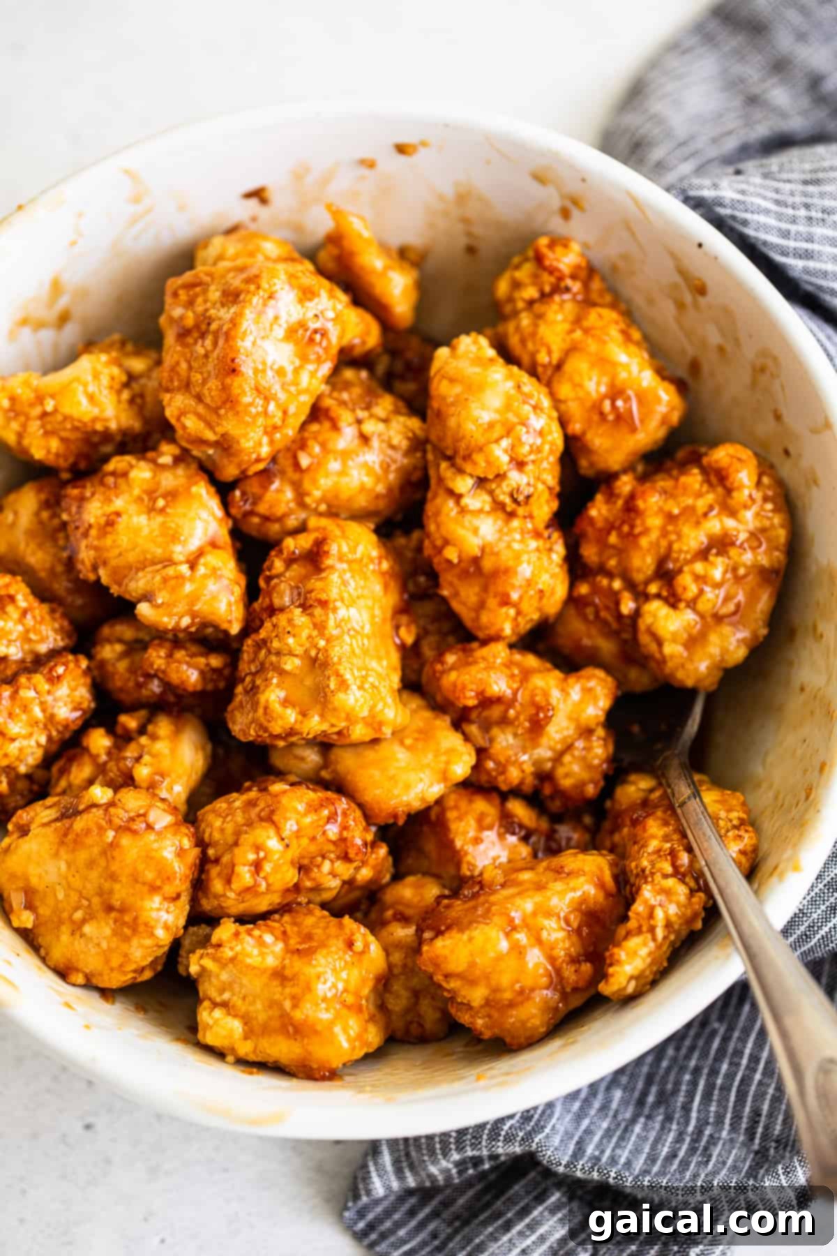 This saucy, delicious air fryer honey sesame chicken is ready in 30 minutes and tastes deep-fried, but it's actually made in the air fryer! air fryer chicken tossed in sauce