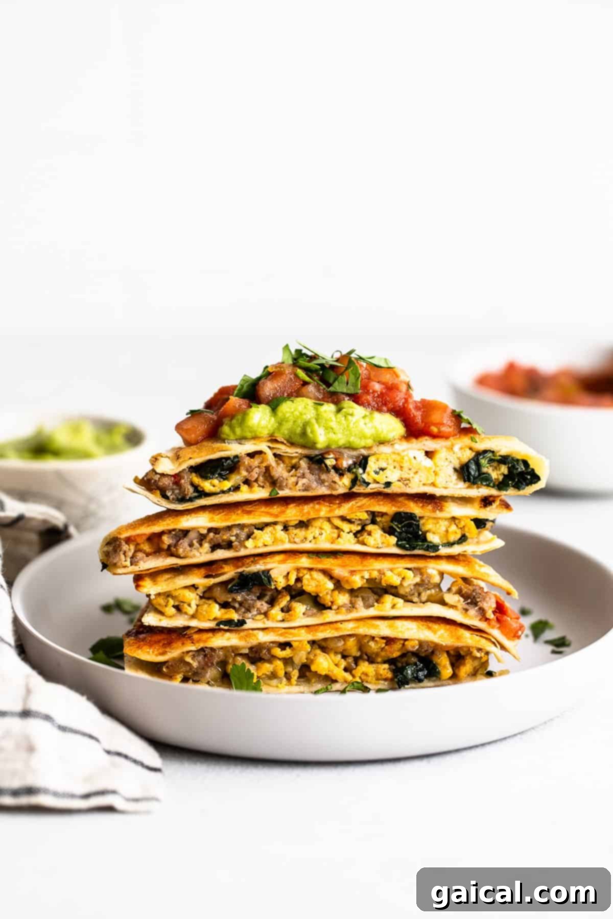 Make-Ahead Freezer Breakfast Quesadillas: Your Go-To Morning Solution Stacked make-ahead freezer breakfast quesadillas on a plate, ready to be enjoyed.